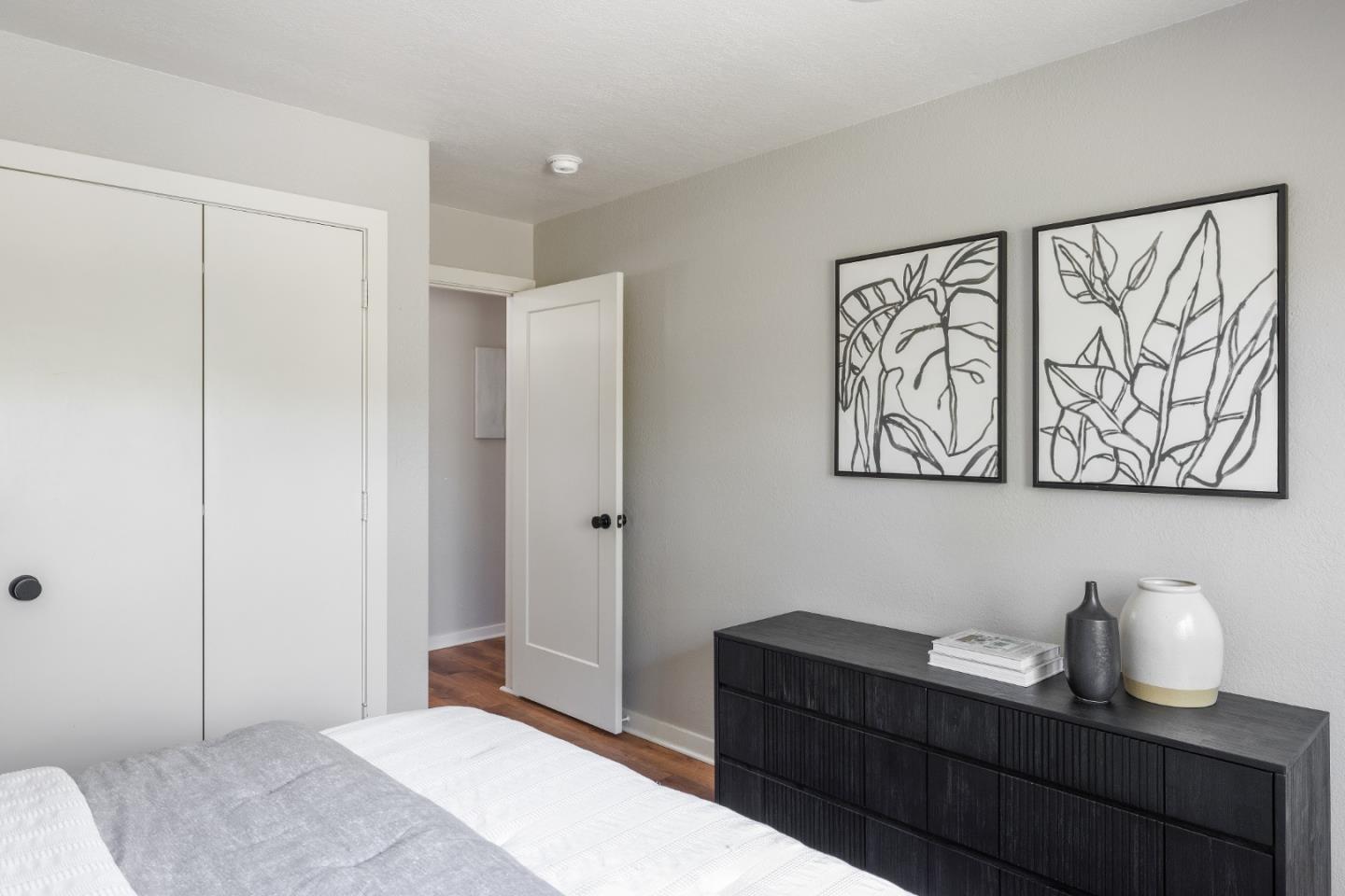 25165 Stewart Place Carmel, CA 93923 - Photo 32 of 51 a bedroom with a bed and paintings on the wall