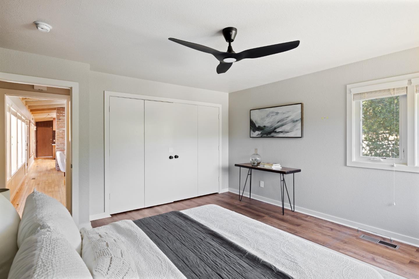 25165 Stewart Place Carmel, CA 93923 - Photo 37 of 51 a bedroom with a bed and a chandelier