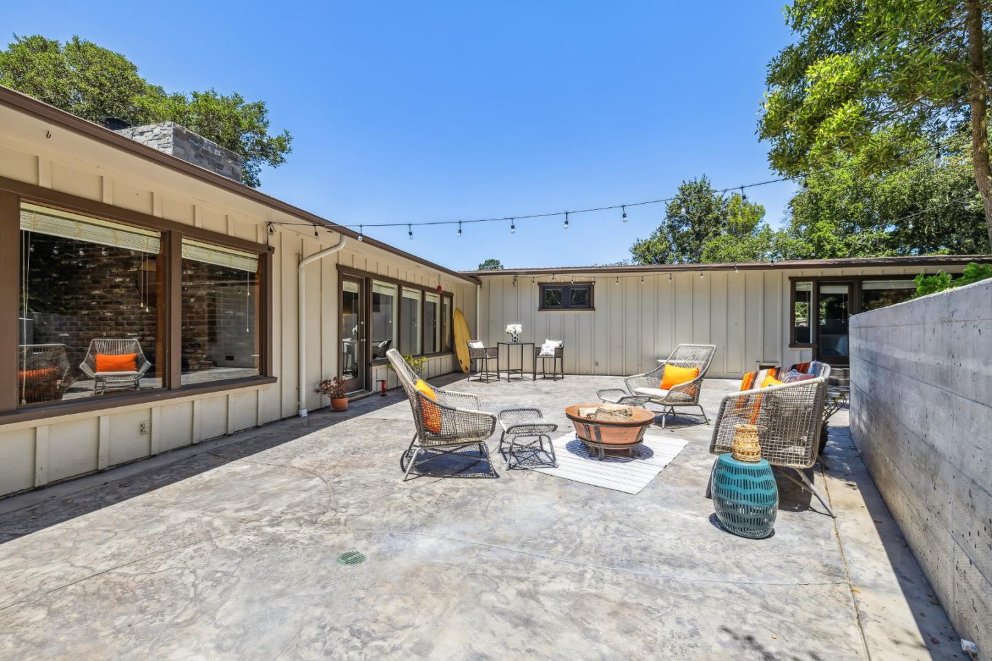 25165 Stewart Place Carmel, CA 93923 - Photo 40 of 51 a backyard of a house with barbeque oven table and chairs
