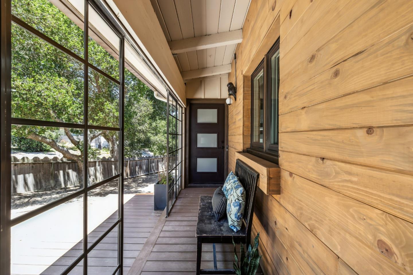 25165 Stewart Place Carmel, CA 93923 - Photo 5 of 51 a view of a porch with wooden floor and furniture