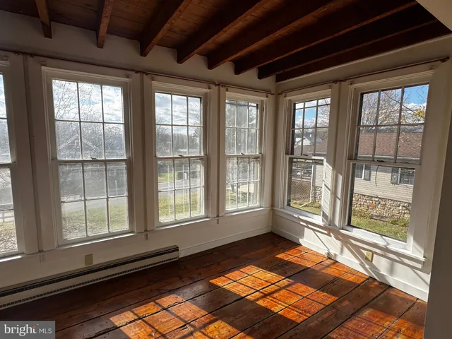 a view of a room with wooden floor