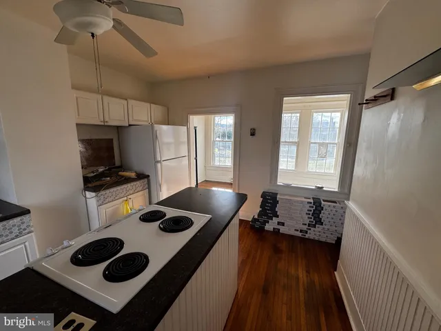 a kitchen with a stove and a refrigerator