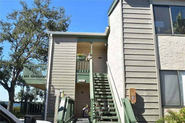 a view of a balcony with wooden floor and fence