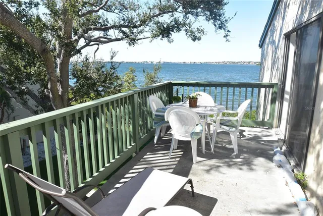a view of a chairs and table in the balcony