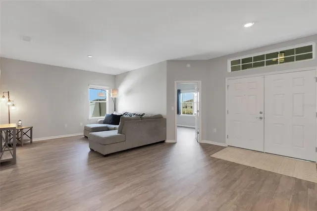 a view of an empty room with wooden floor