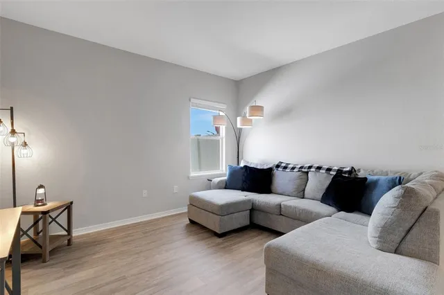 a living room with furniture and a lamp