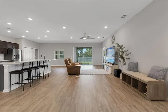 a living room with furniture and kitchen view