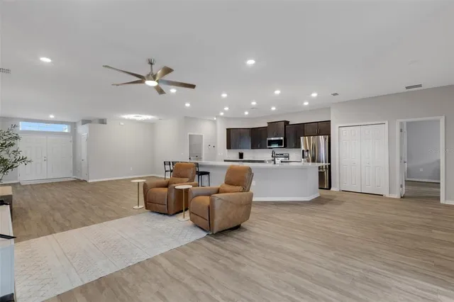 a kitchen with stainless steel appliances a refrigerator and a stove top oven