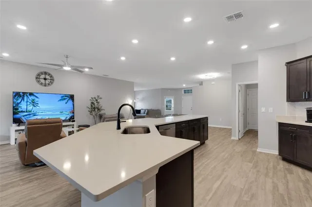a kitchen with a sink and a mirror