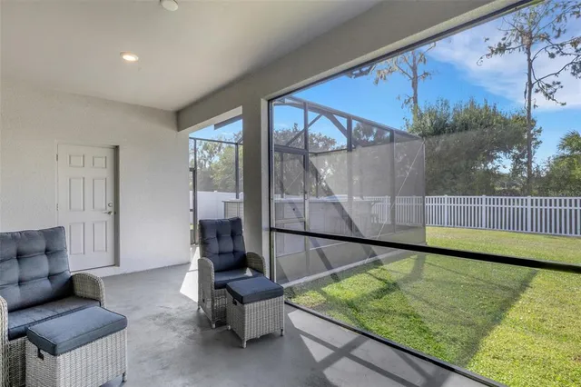 an aerial view of a residential house with a yard