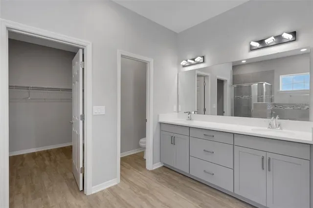 a bathroom with a double vanity sink and a mirror