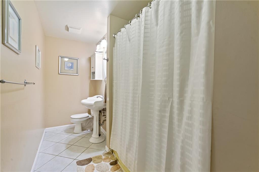 1318 Sky Ridge Drive Pittsburgh, PA 15241 - Photo 15 of 33 a white toilet sitting next to a shower curtain