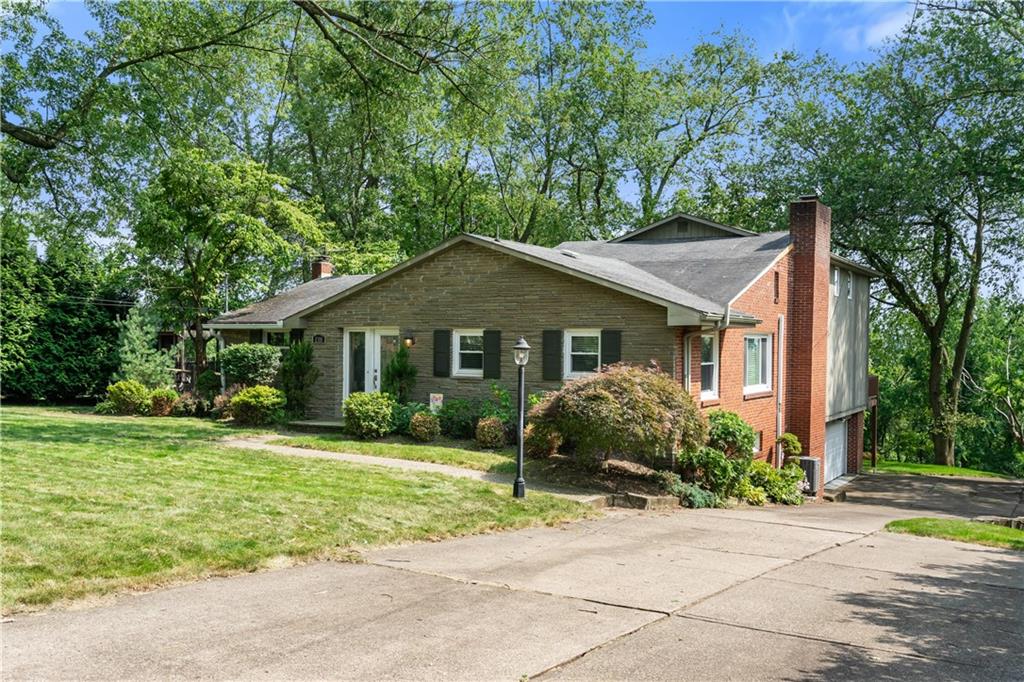 1318 Sky Ridge Drive Pittsburgh, PA 15241 - Photo 33 of 33 a front view of a house with a yard and potted plants