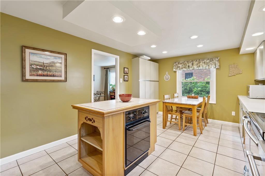 1318 Sky Ridge Drive Pittsburgh, PA 15241 - Photo 5 of 33 a kitchen with a stove a sink a table and chairs