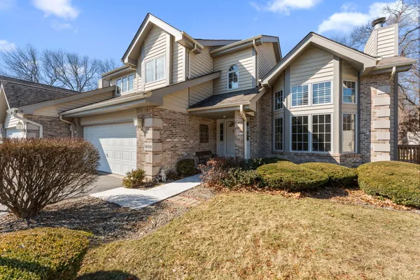 a view of a brick house with a yard