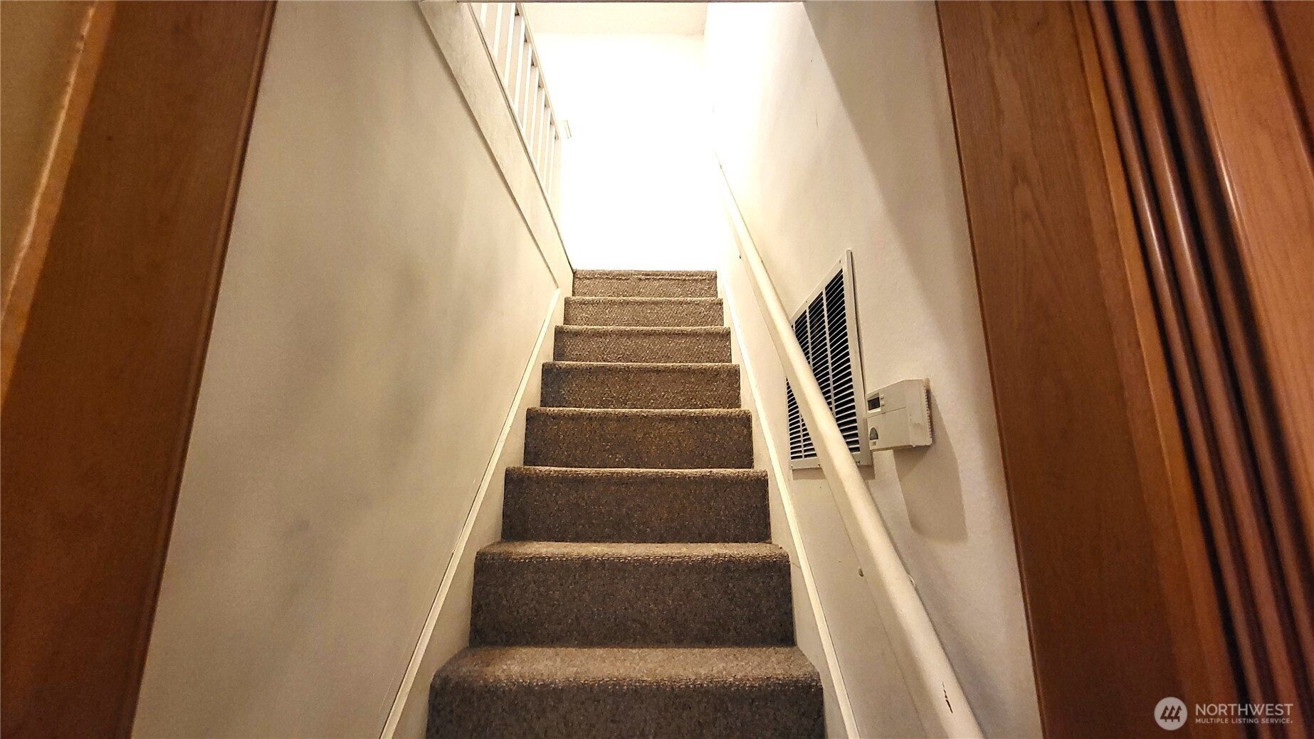 1113 South County Road Warden, WA 98857 - Photo 23 of 40 a view of staircase with white walls and white door