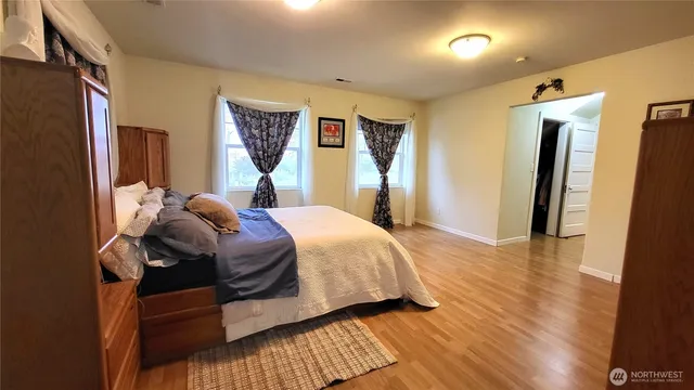a bed sitting in a bedroom next to a window