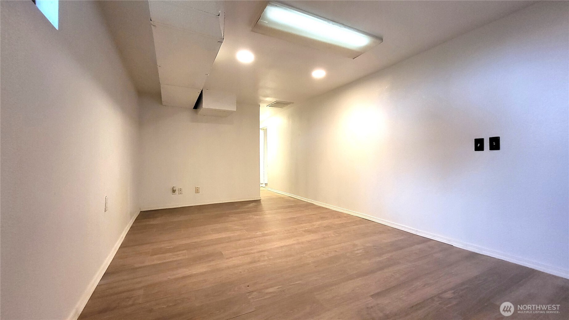 1113 South County Road Warden, WA 98857 - Photo 38 of 40 an empty room with wooden floor and windows