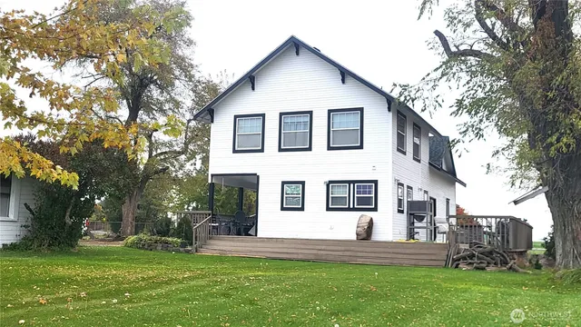 a front view of a house with a yard and trees
