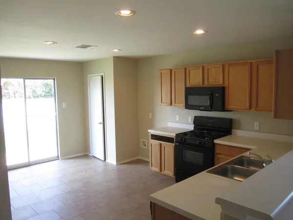 a kitchen that has a sink and a stove in it