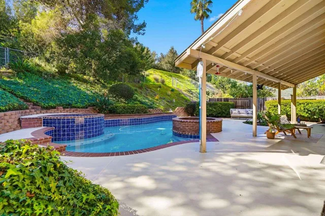 a view of a backyard with wooden fence