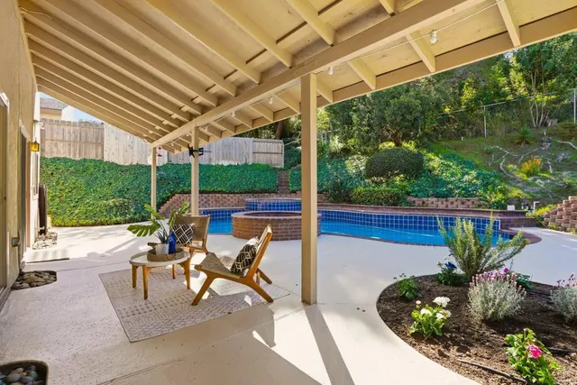 a view of a patio with table and chairs potted plants with wooden floor