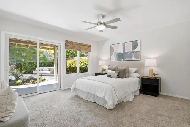 a large bedroom with a bed and a large window