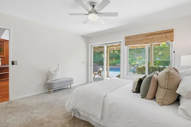 a bedroom with a bed and large window