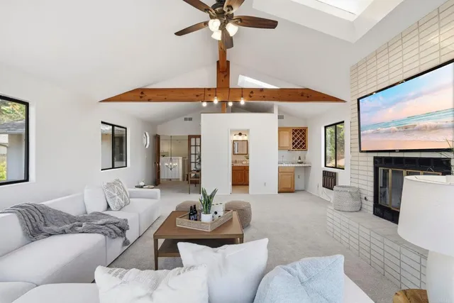 a living room with furniture a fireplace and a flat screen tv