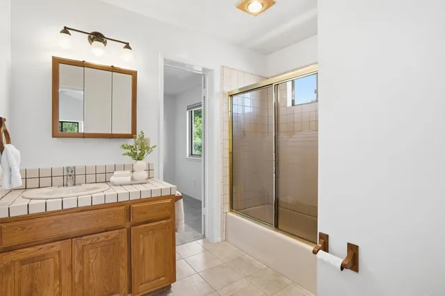 a bathroom with a double vanity sink mirror and shower
