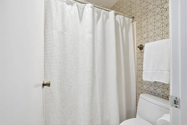 a bathroom with a shower curtain and a curtain