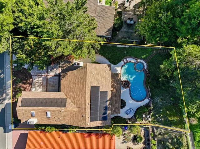 an aerial view of a house with swimming pool outdoor seating and yard