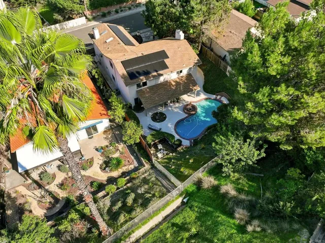 an aerial view of residential house with outdoor space and parking
