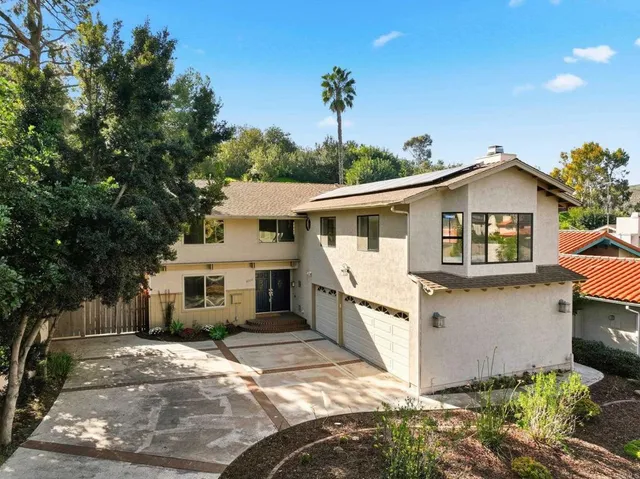 a view of a house with a patio and a yard