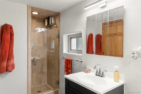 a bathroom with a sink vanity and a mirror