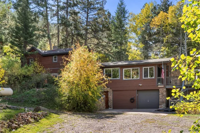 a view of a house with a yard and potted plants