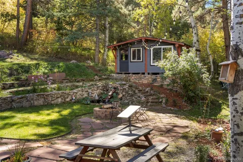 a view of a chair and table in backyard