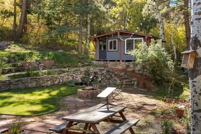 a view of a chair and table in backyard