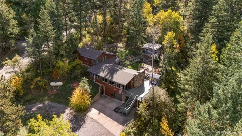 an aerial view of a house with a yard