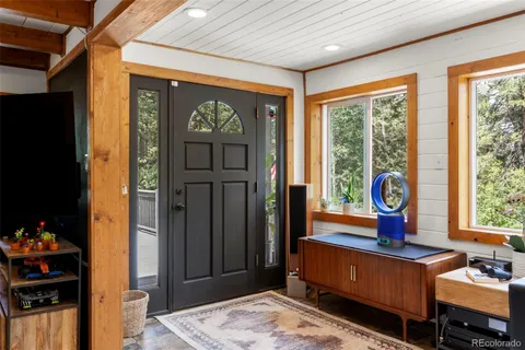 a living room with furniture a window and a flat screen tv