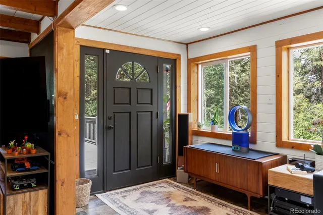 a living room with furniture a window and a flat screen tv