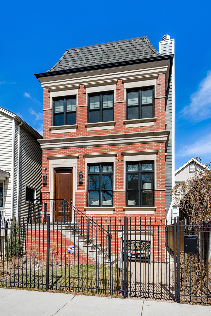 1734 West Fletcher Street Chicago, IL 60657 - Photo 1 of 34 a front view of a house with iron fence