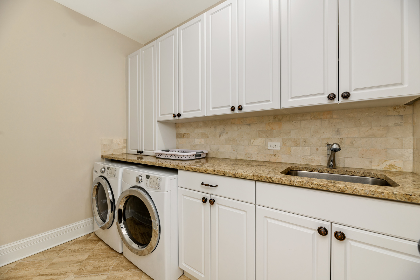1734 West Fletcher Street Chicago, IL 60657 - Photo 14 of 34 a utility room with granite countertop white cabinets and a sink