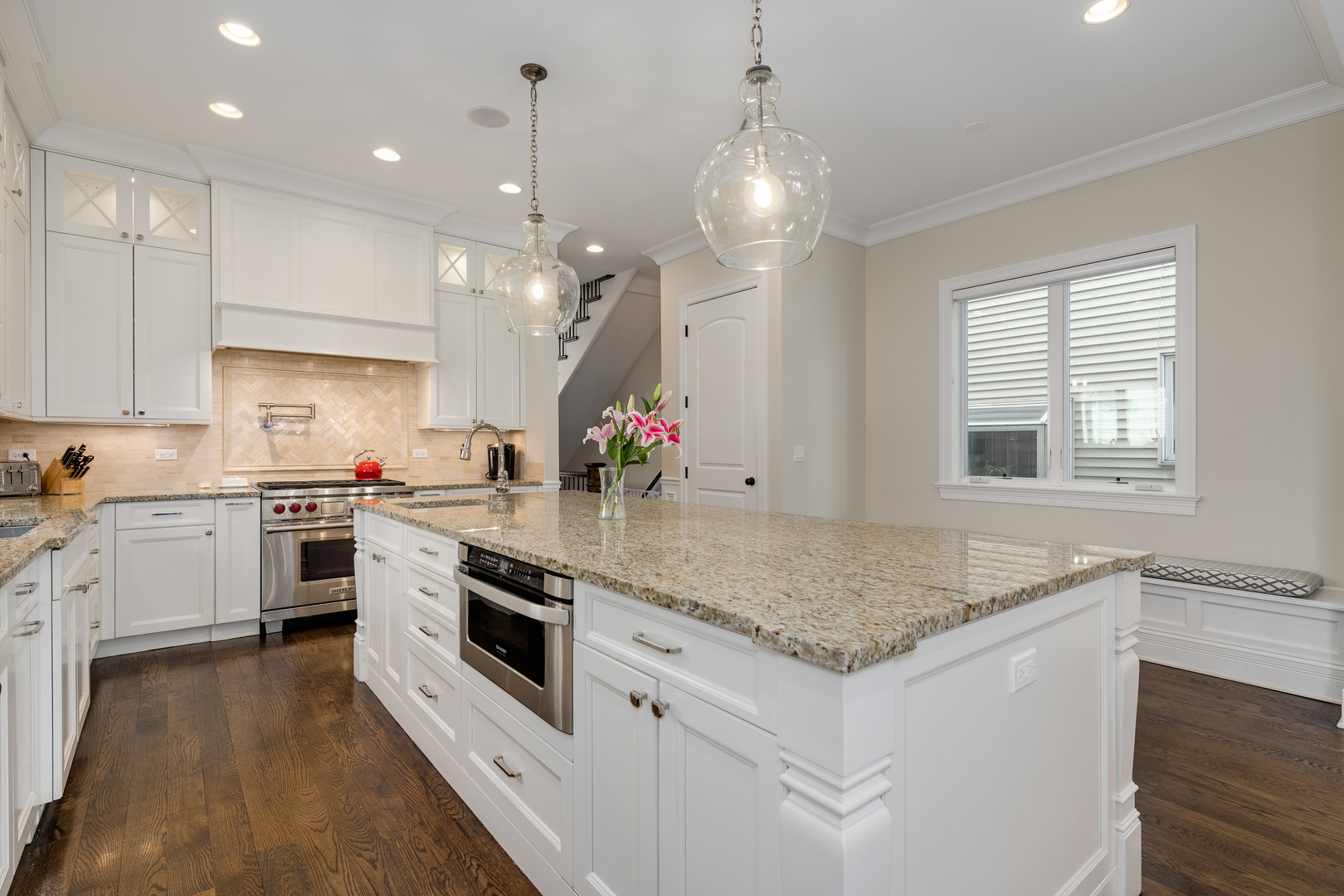 1734 West Fletcher Street Chicago, IL 60657 - Photo 7 of 34 a kitchen with granite countertop white cabinets and white appliances