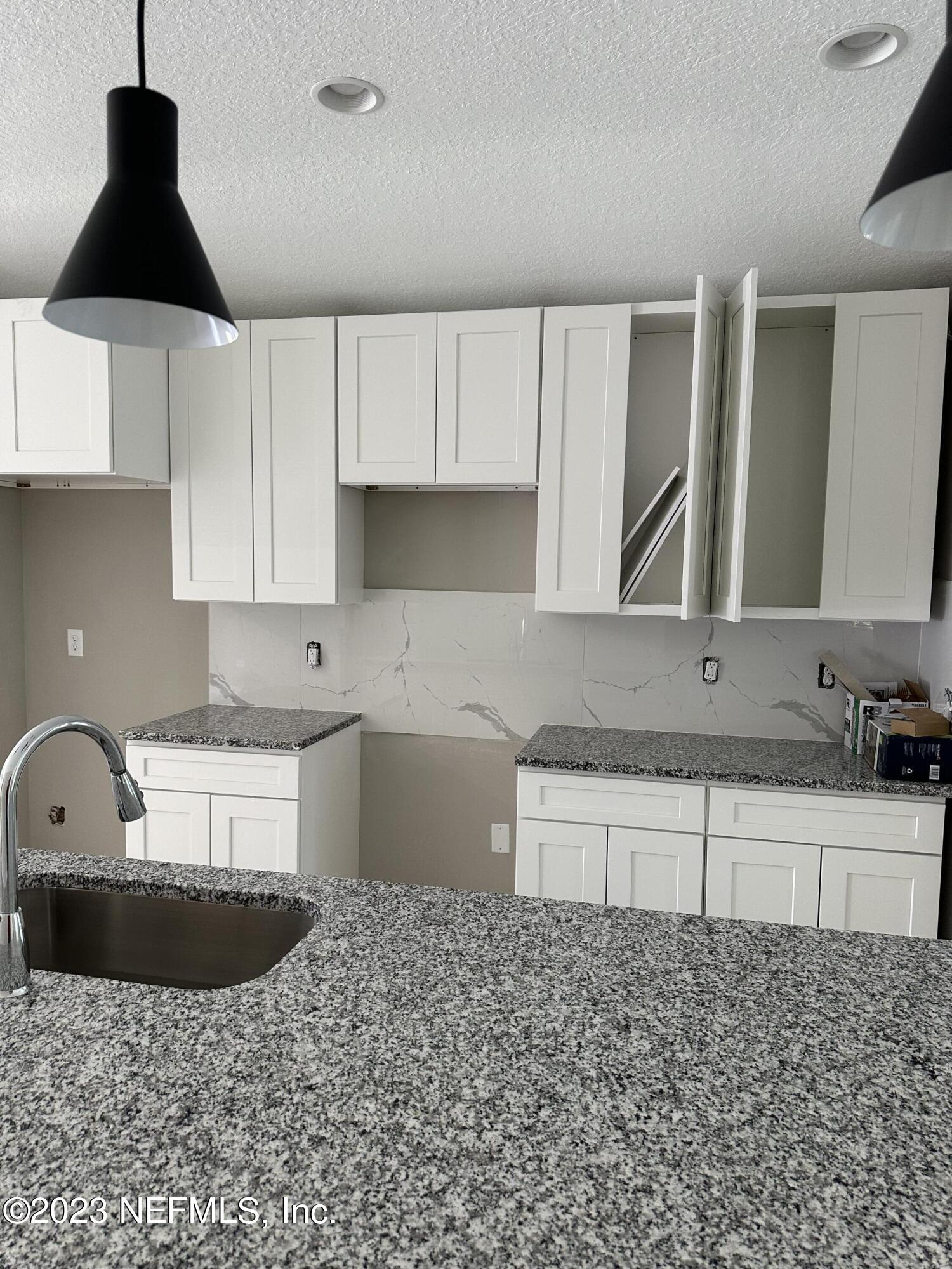 2829 Fleming Street Jacksonville, FL 32254 - Photo 15 of 24 a kitchen with a sink a stove and cabinets