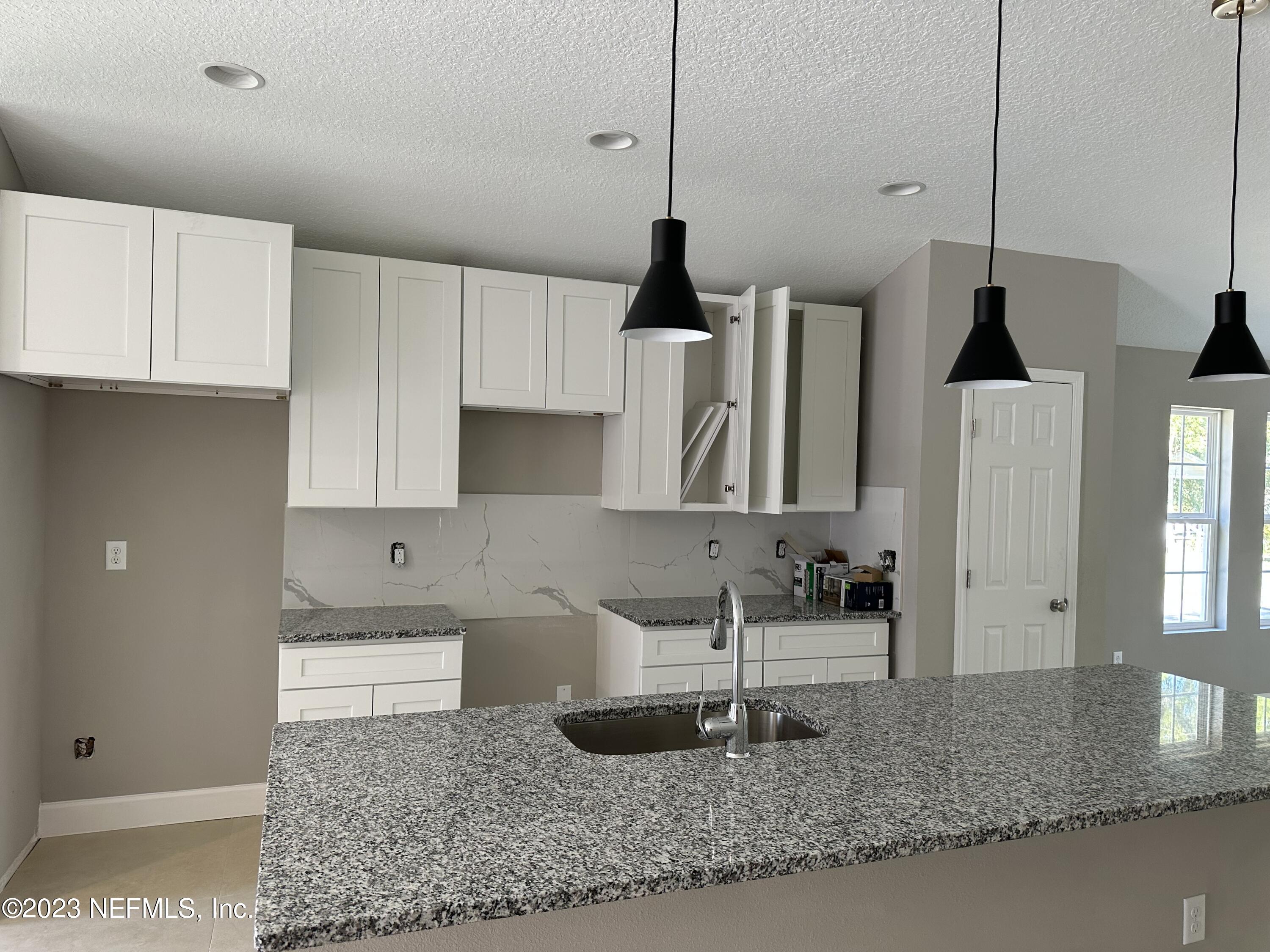 2829 Fleming Street Jacksonville, FL 32254 - Photo 16 of 24 a kitchen with stainless steel appliances granite countertop a sink a stove and a refrigerator