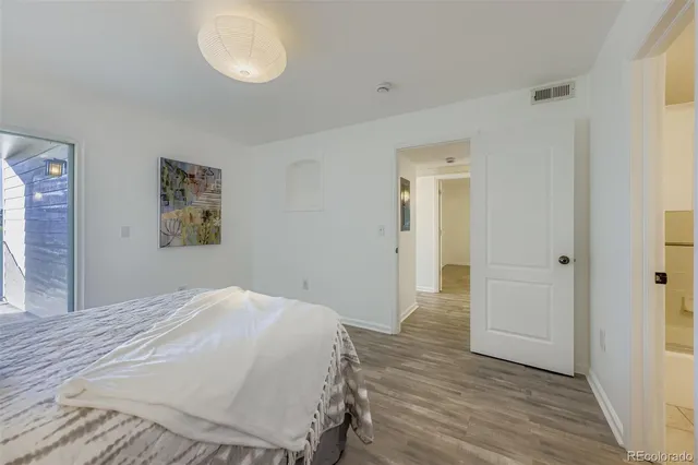 a spacious bedroom with a bed and a cabinets