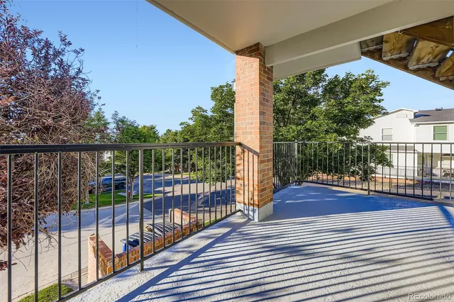 a view of a balcony with wooden floor