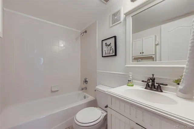 a bathroom with a sink a toilet and bathtub