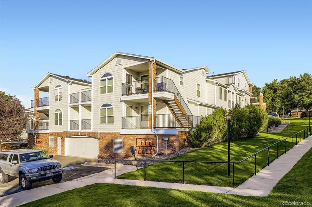 a front view of a residential apartment building with a yard